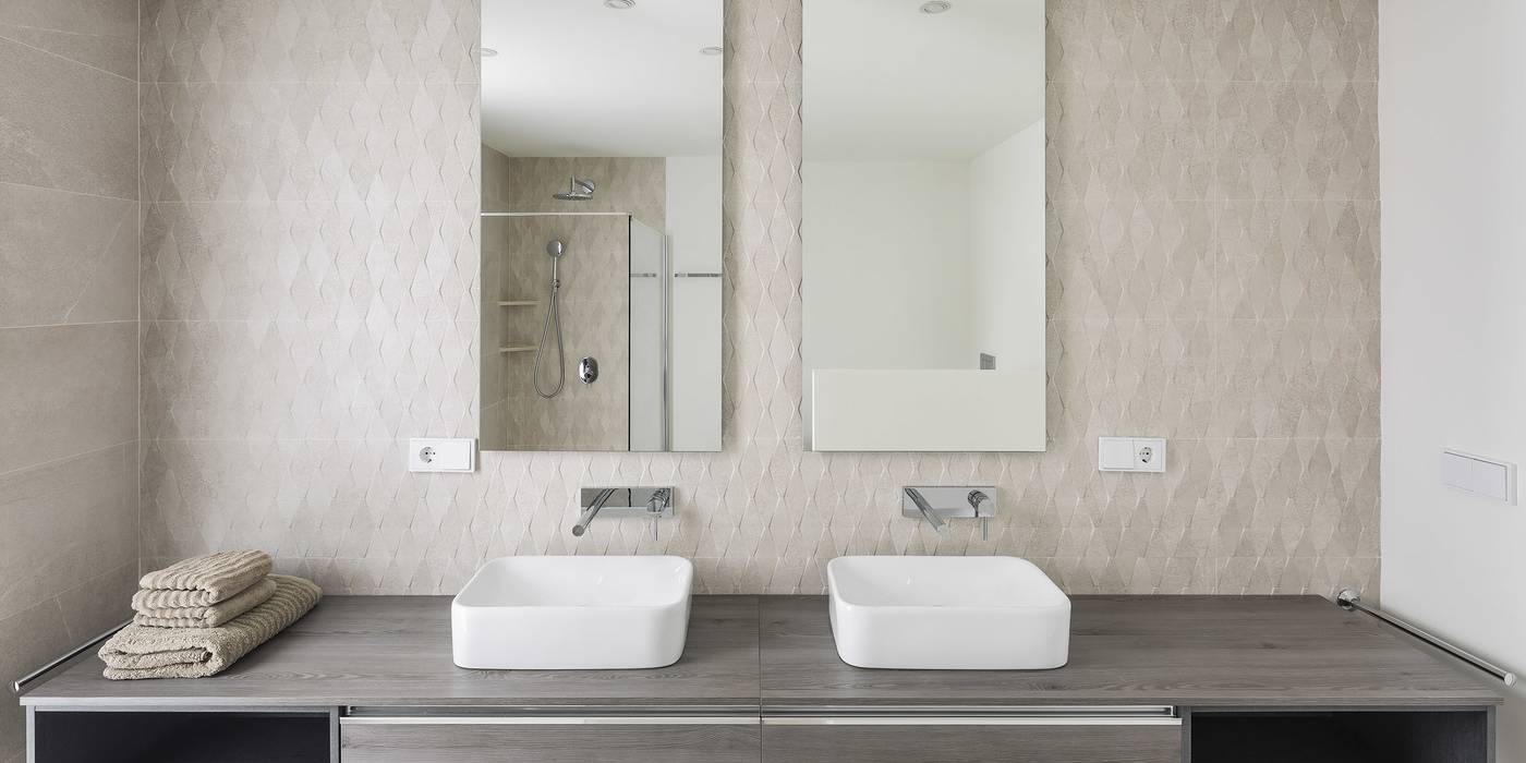 Symmetrical modern bathroom with LED lighting and natural marble